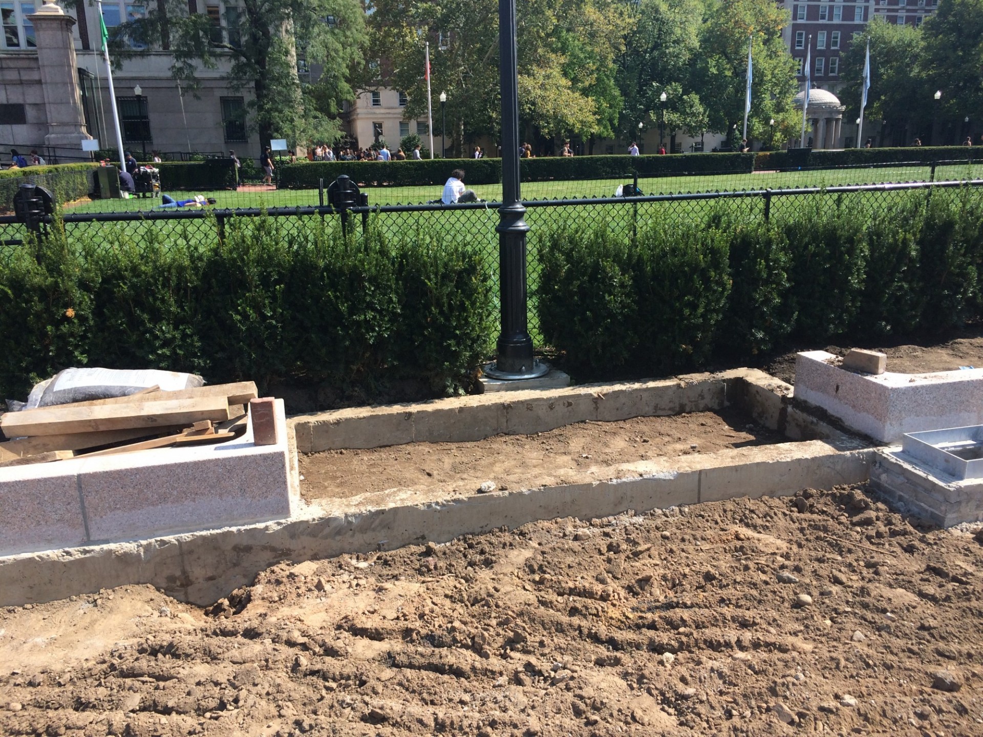 New benches will line the pathways along the perimeter of Butler Lawn. The area for a bench can be seen in this photo in front of the lamppost. (Photo from September 11, 2017)