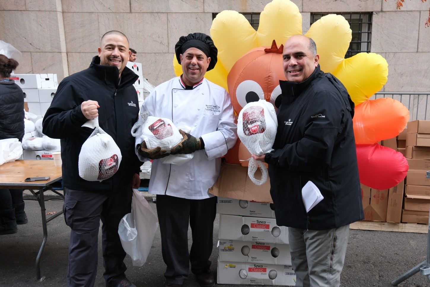 CUFO employees holding frozen turkeys