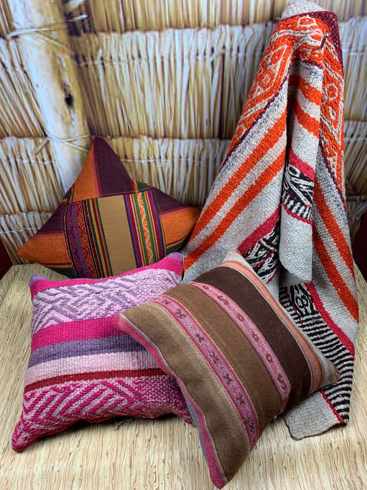 Three pillows and rug handcrafted with several colors mixed throughout