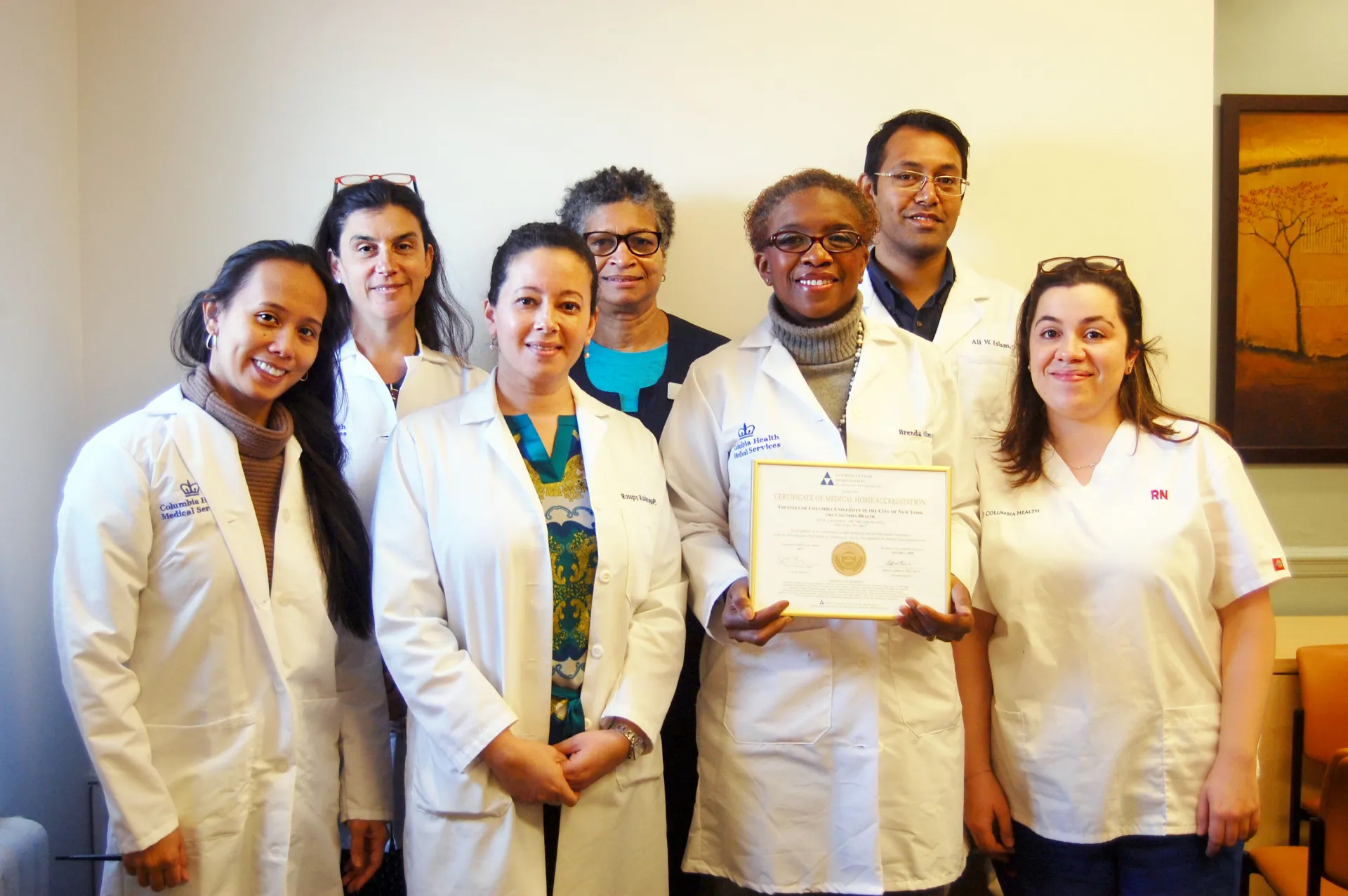 Members of the Columbia Health Medical Services team display the AAAHC certification.