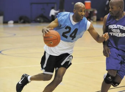 David Forbes, Director of Physical Plant, closely guards the opposing team. 