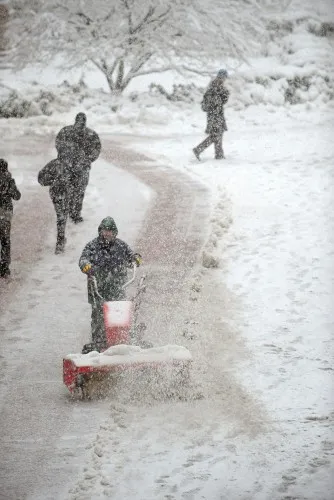  Community members trudge through another blizzard, as our team clears the area near Uris Hall. 
