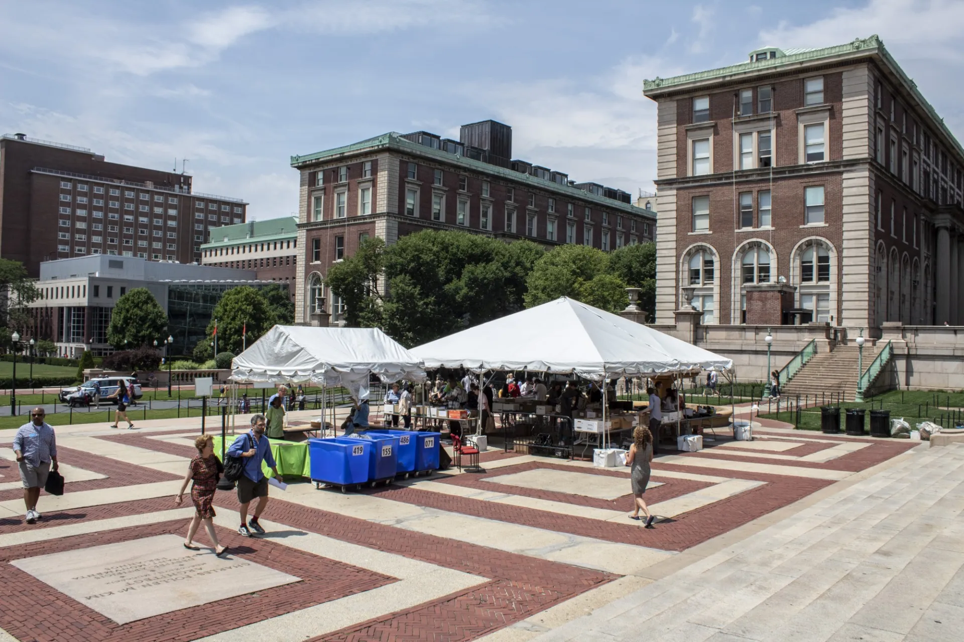 People view donated items underneath white tents on Low Plaza