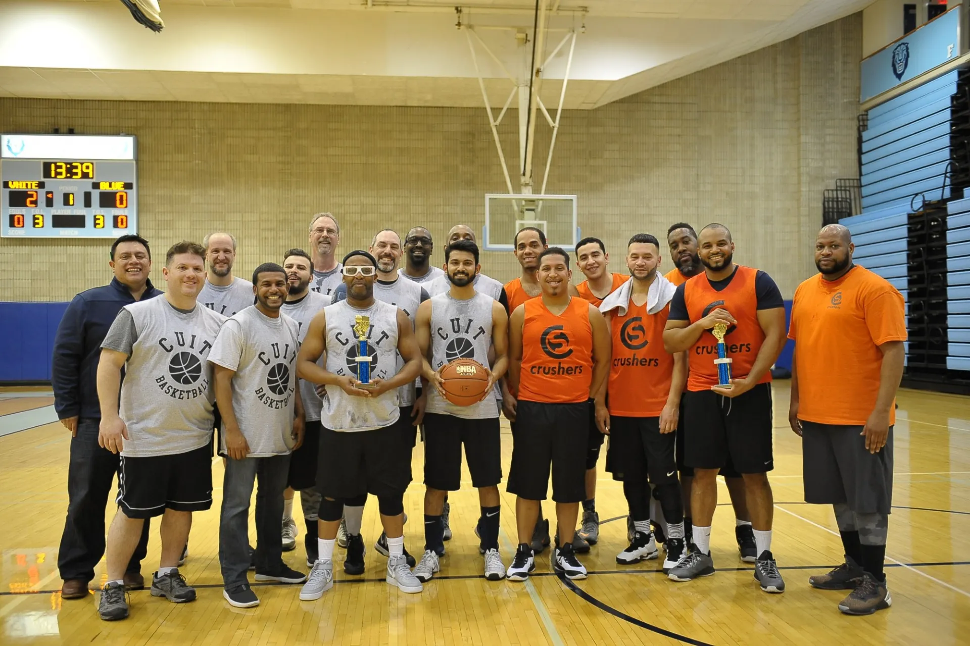 The CUIT and Campus Services teams pose together with consolation trophies.