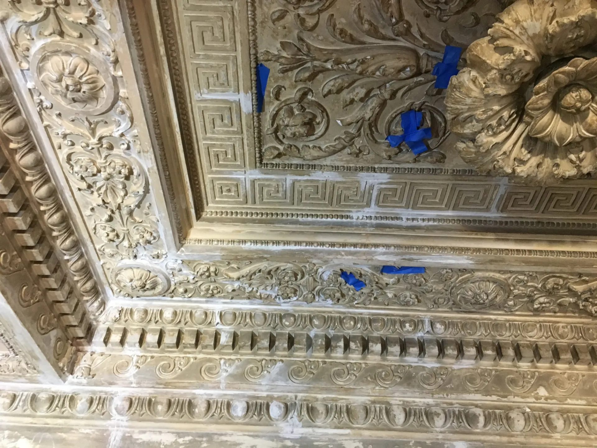 Repairs in progress of the ornate plaster ceiling. The repairs require close attention to detail and careful work to maintain the integrity of the historic ceiling.