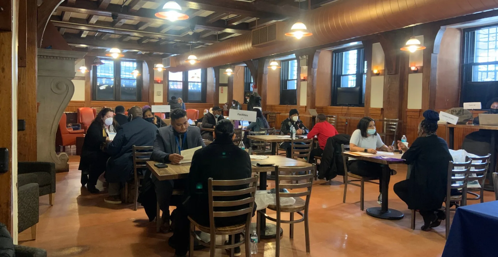 A candid photo of job fair attendees and hiring managers meeting one-on-one of the CUFO job fair.
