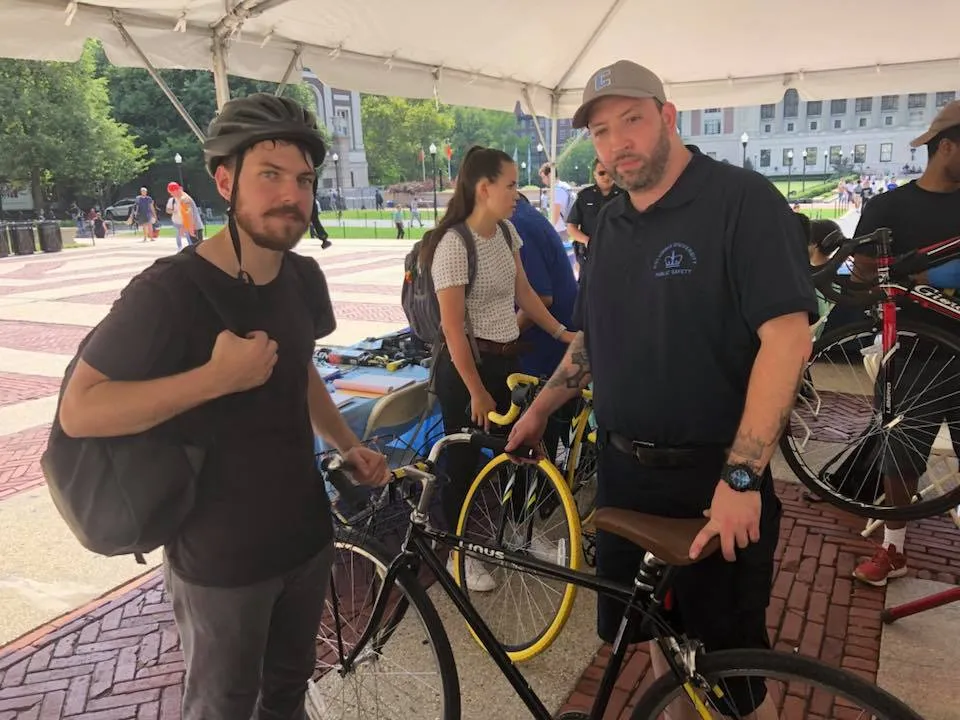 Public Safety Security Officer James Dooner helps a student cyclist