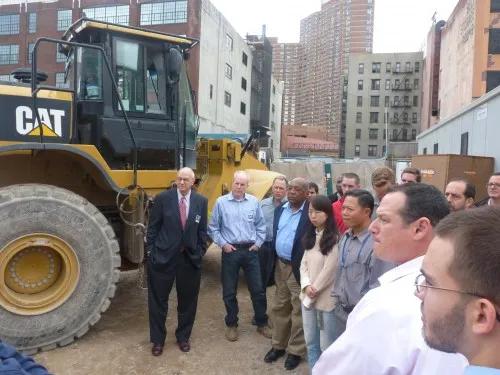 Participants observe a field test of exhaust emissions from a US EPA Tier 4i compliant Caterpillar 966K wheel loader which features advanced emission control technologies 