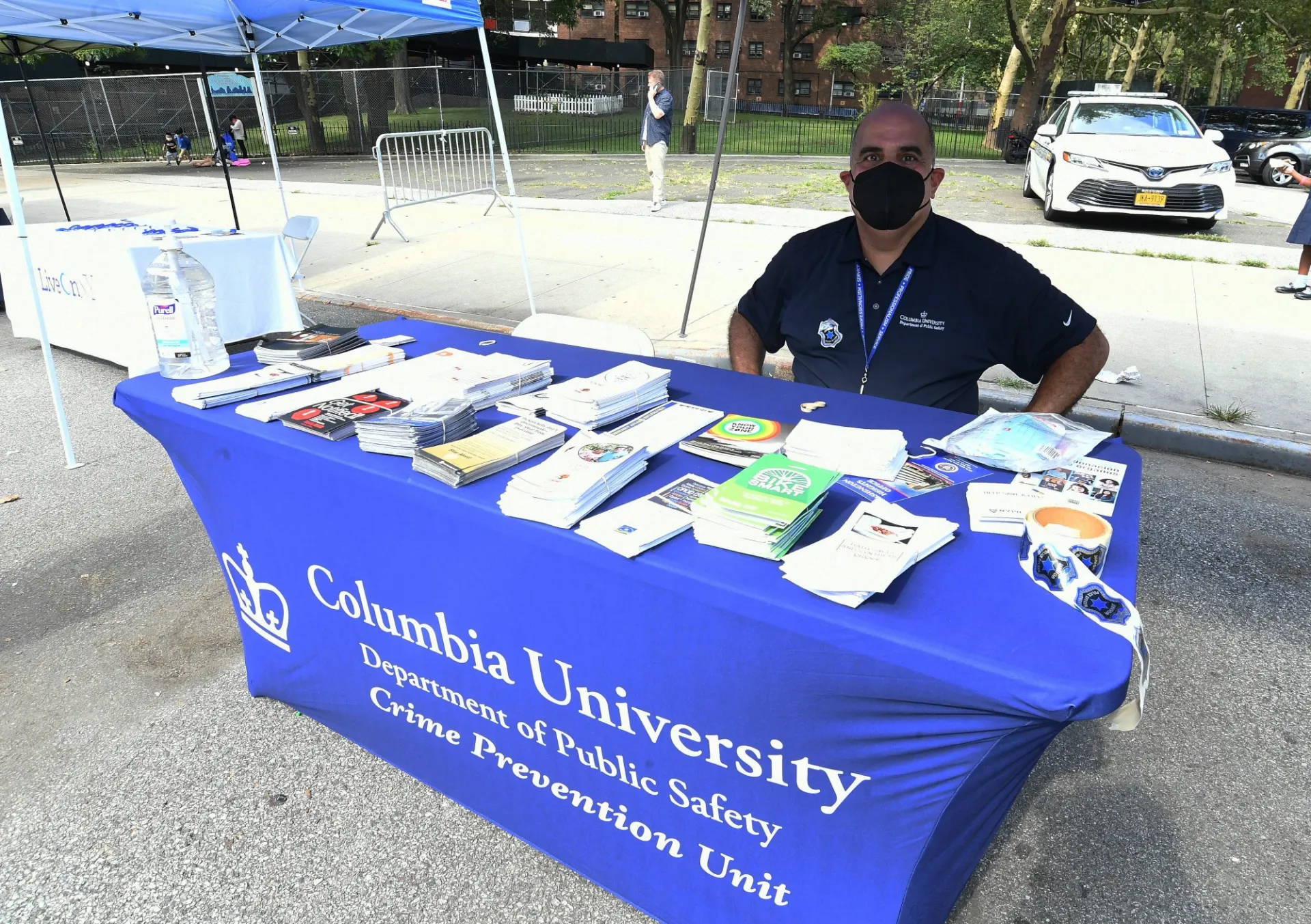 public safety team member sitting behind a desk with crime prevention resources and brochures 
