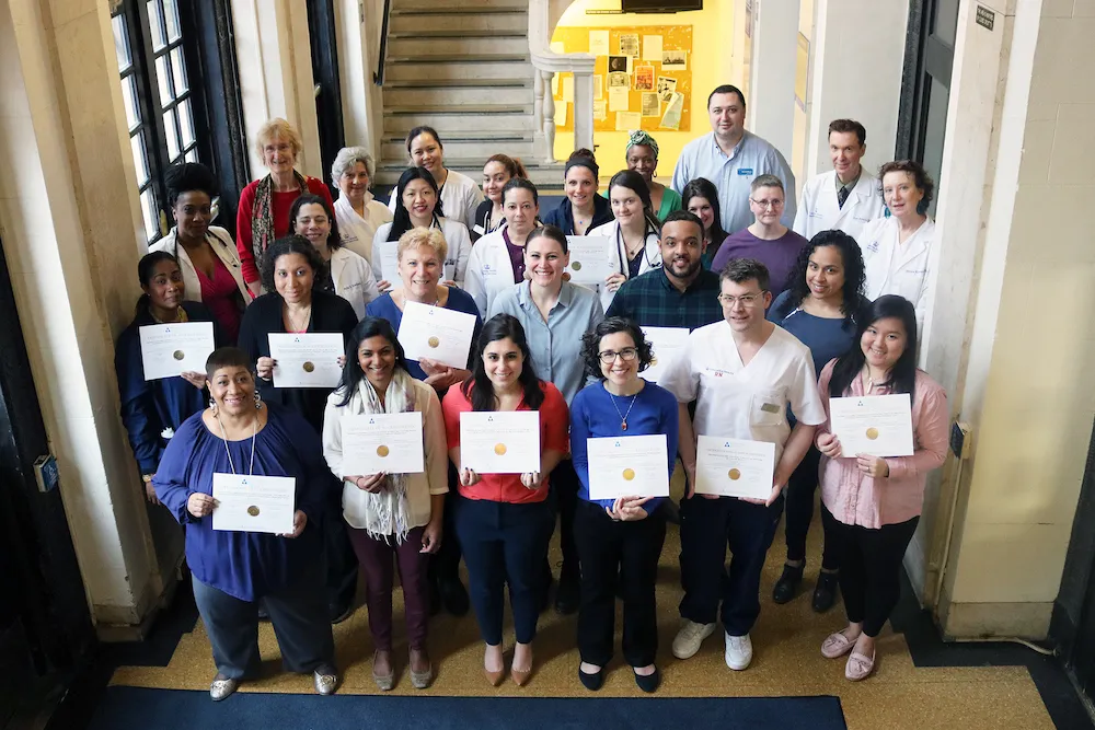 Photo of representative members of the Columbia Health team with accreditation certificates