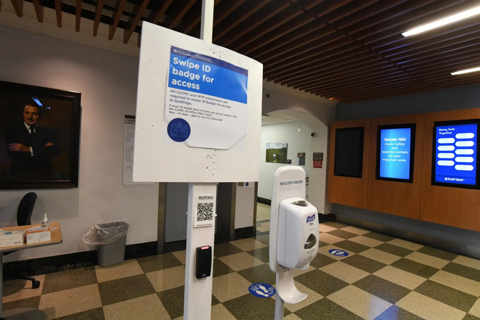 Swipe ID badge for access signage and hand sanitizer station at CUIMC