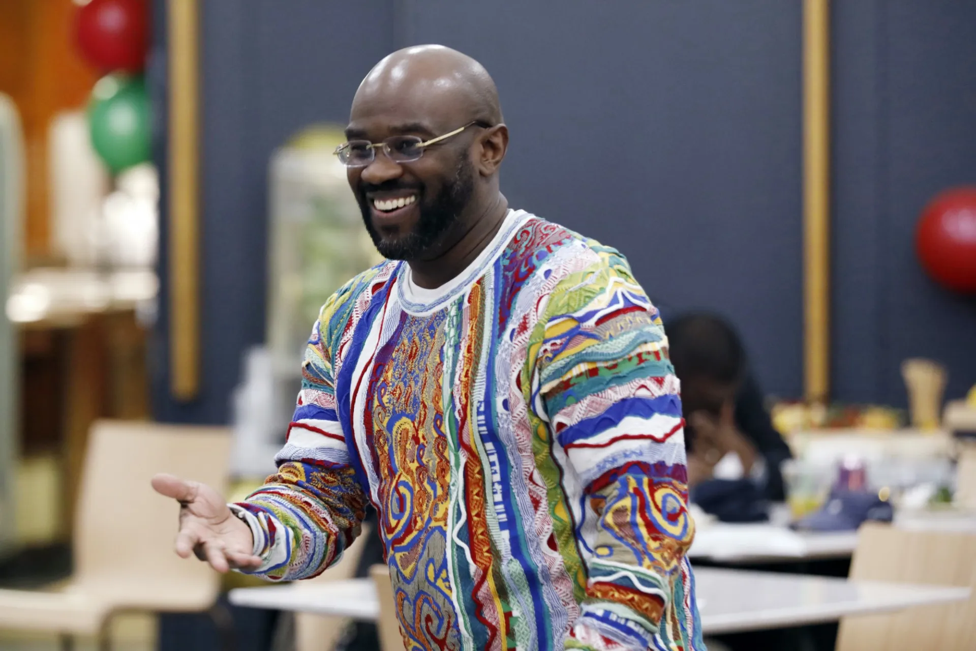 Anderson Smith smiles and extends his hand to event attendees.
