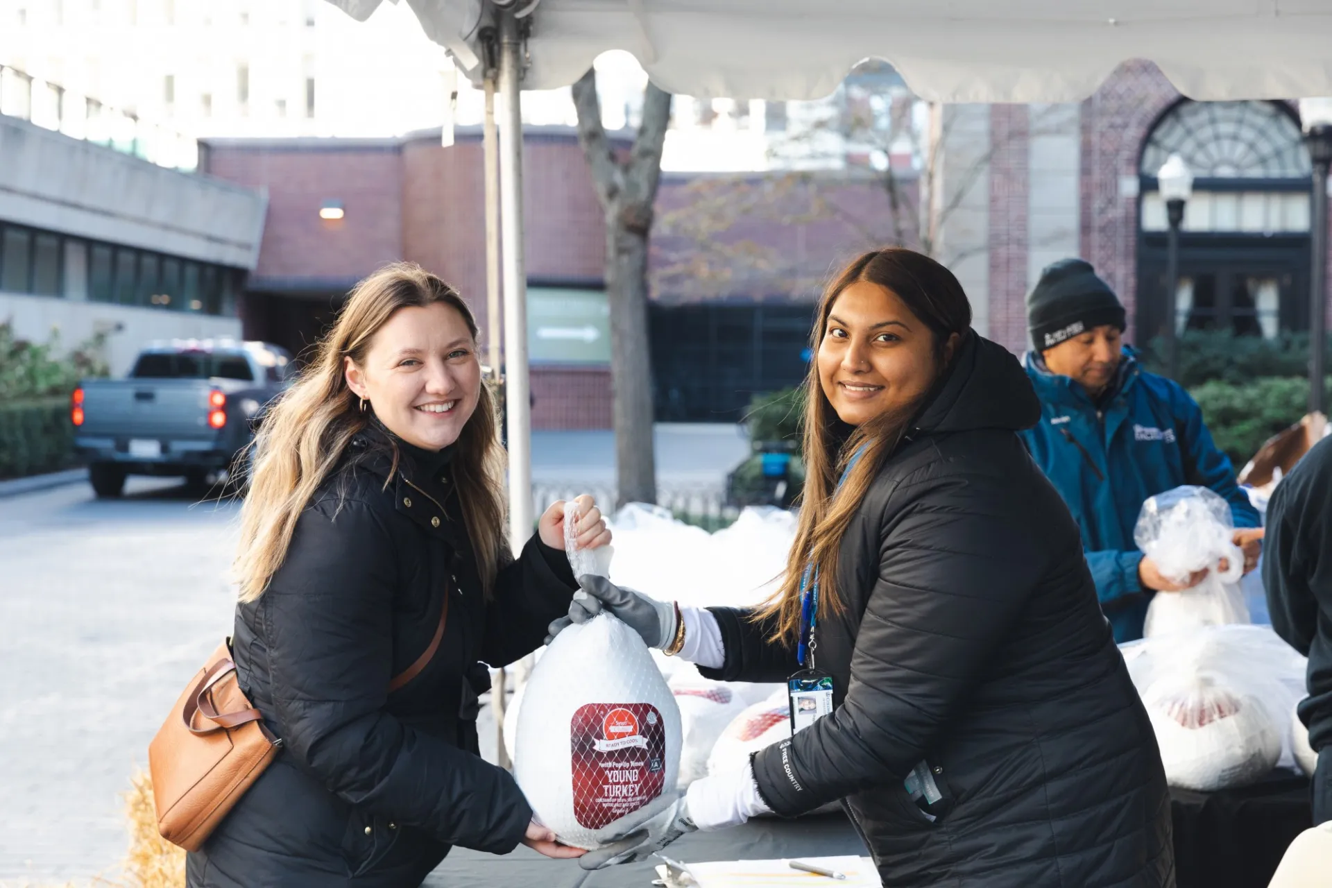 Columbia Residential hands turkey to CUFO employee. 