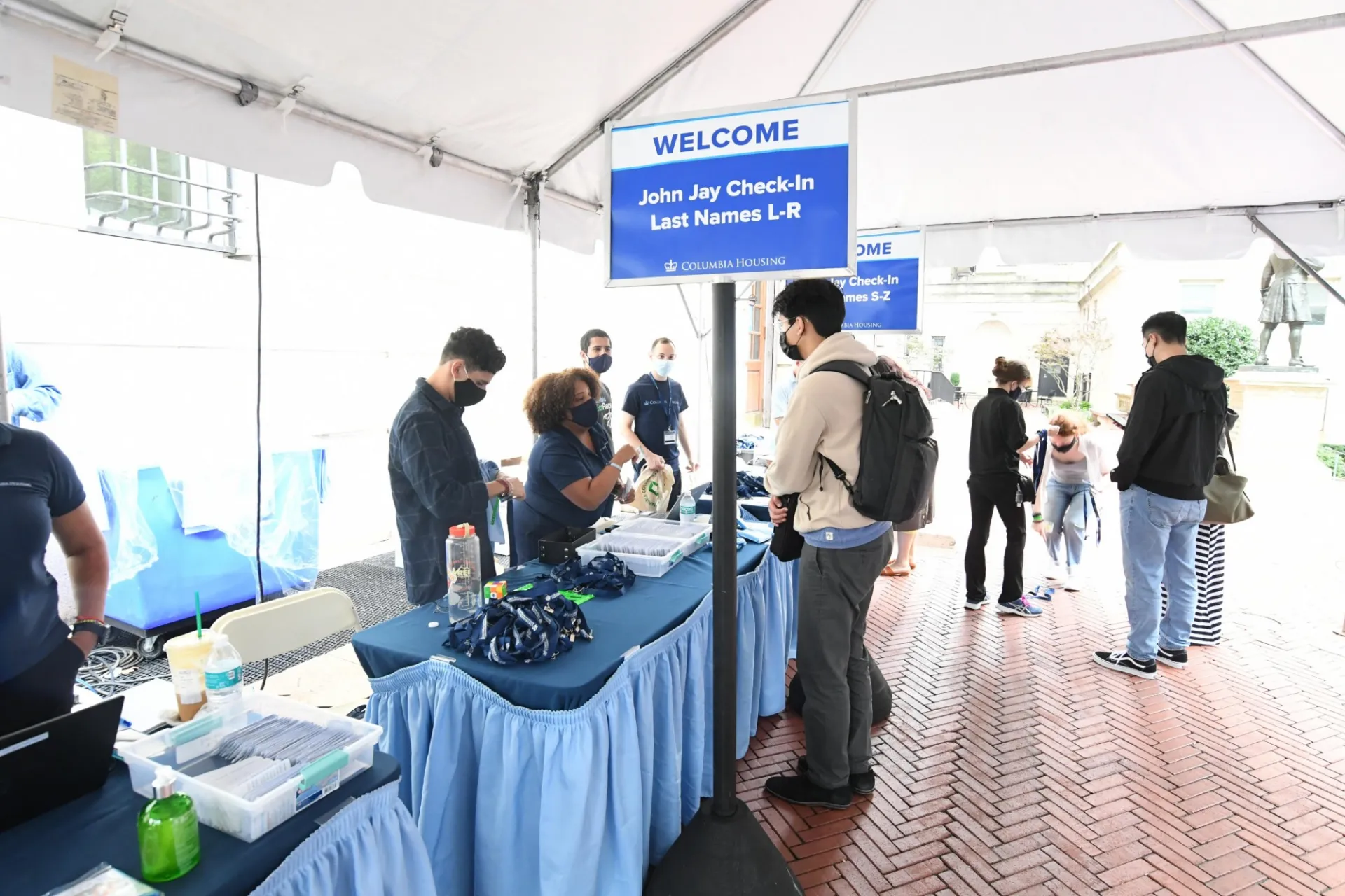 The Housing team greets a First-Year student at the John Jay station
