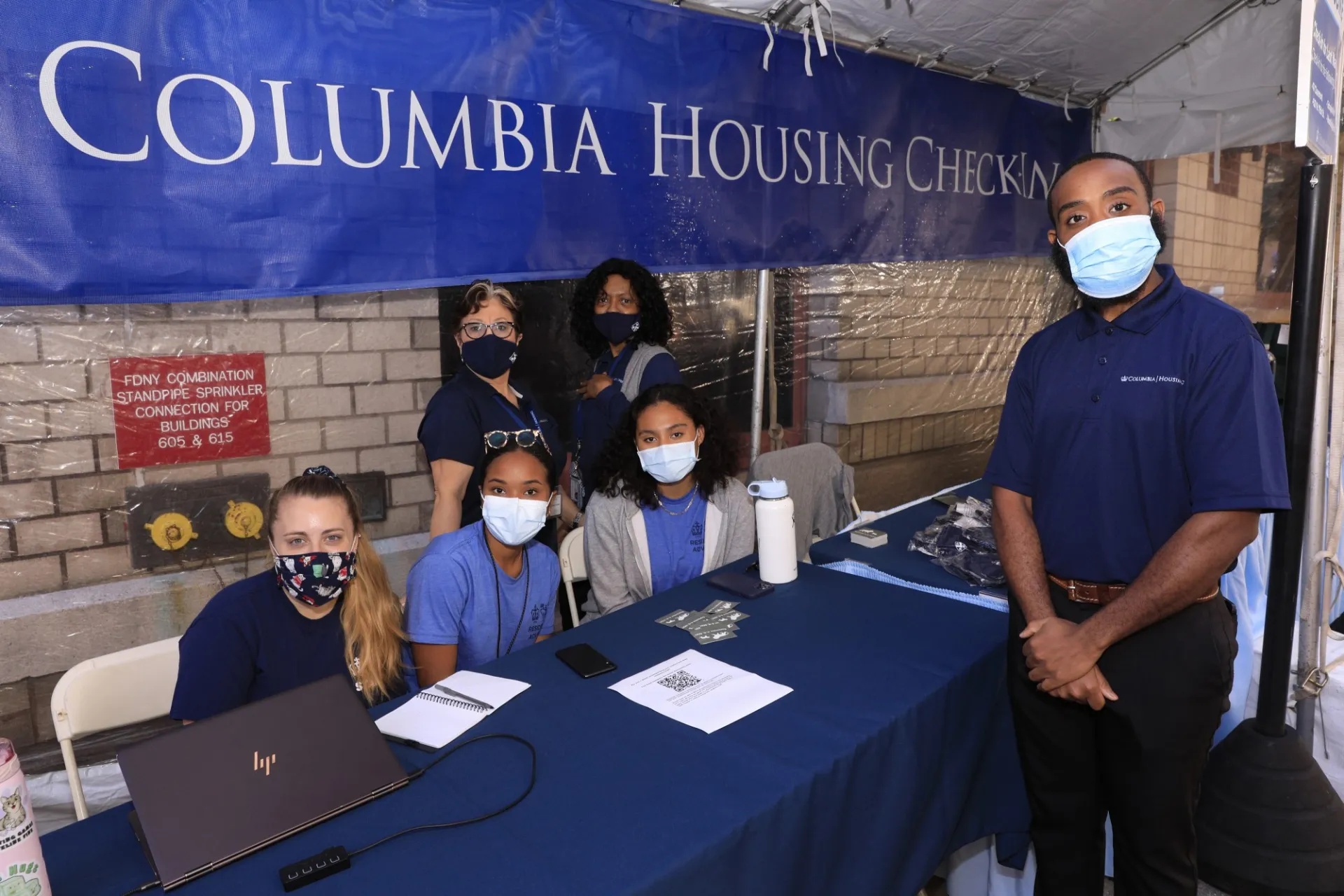 Members of the Housing team stationed with RAs at a Check-In table