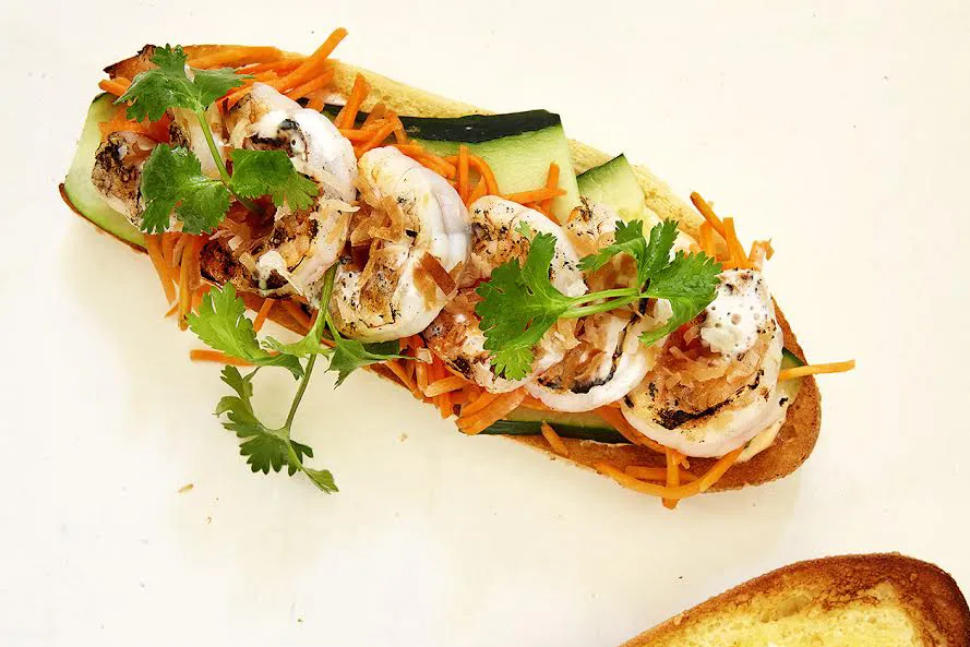 A coconut shrimp sandwich on a hoagie bread.