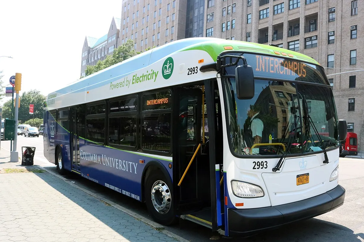 The Intercampus shuttle waits at a stop for people to arrive and get on.