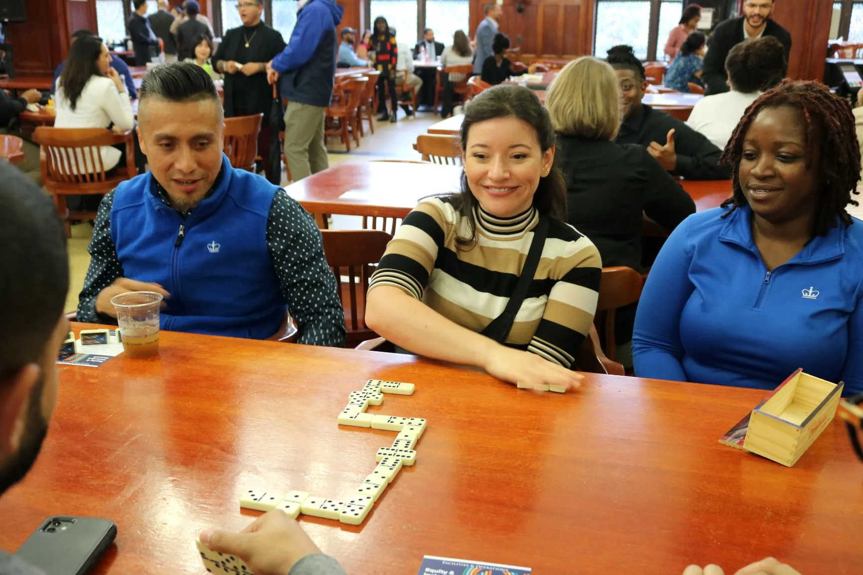 Attendees from the Columbia Housing and Lerner Operations team face off in a game of Dominoes.