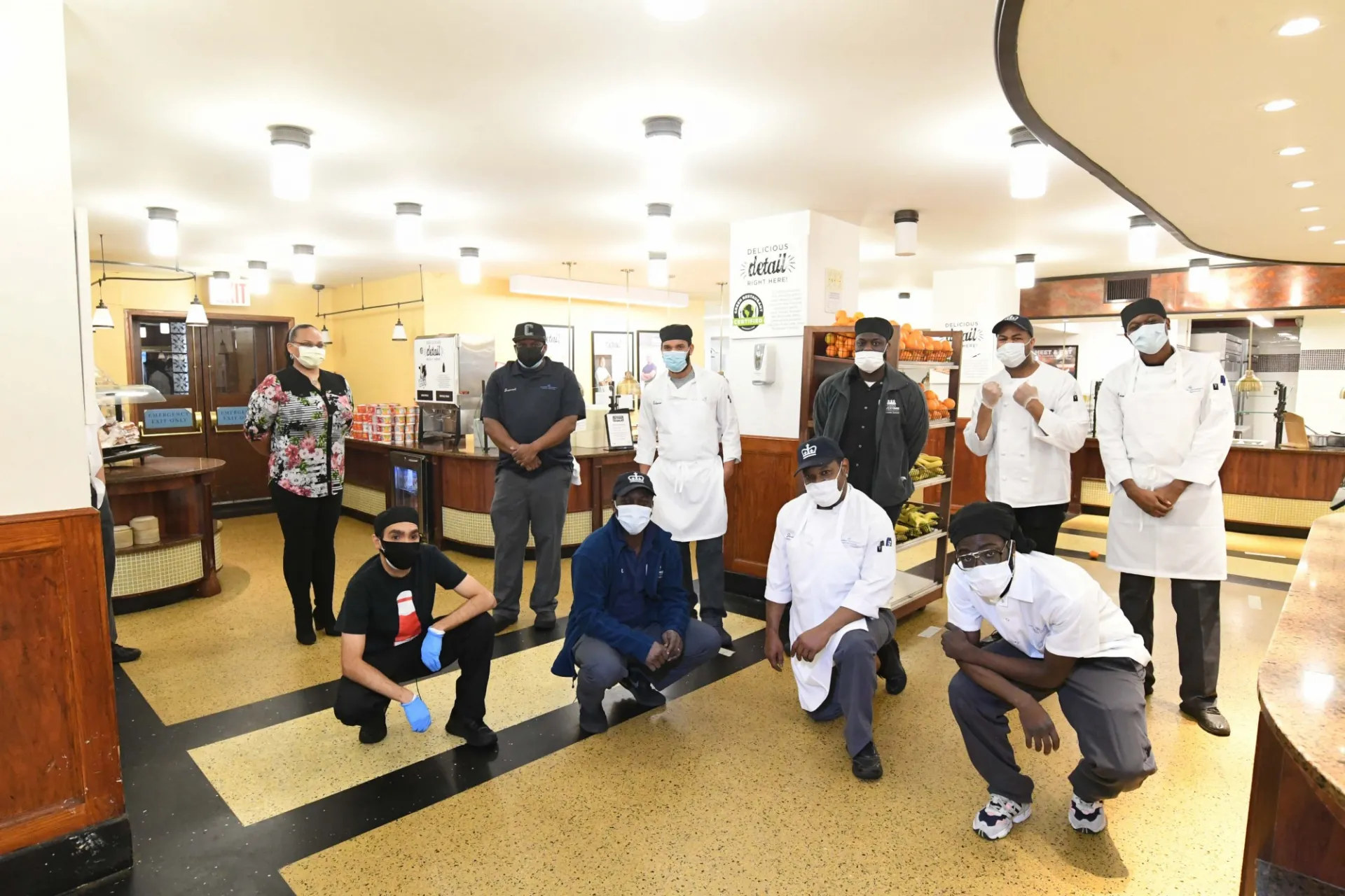 A group of Dining workers stand in John Jay dining hall.