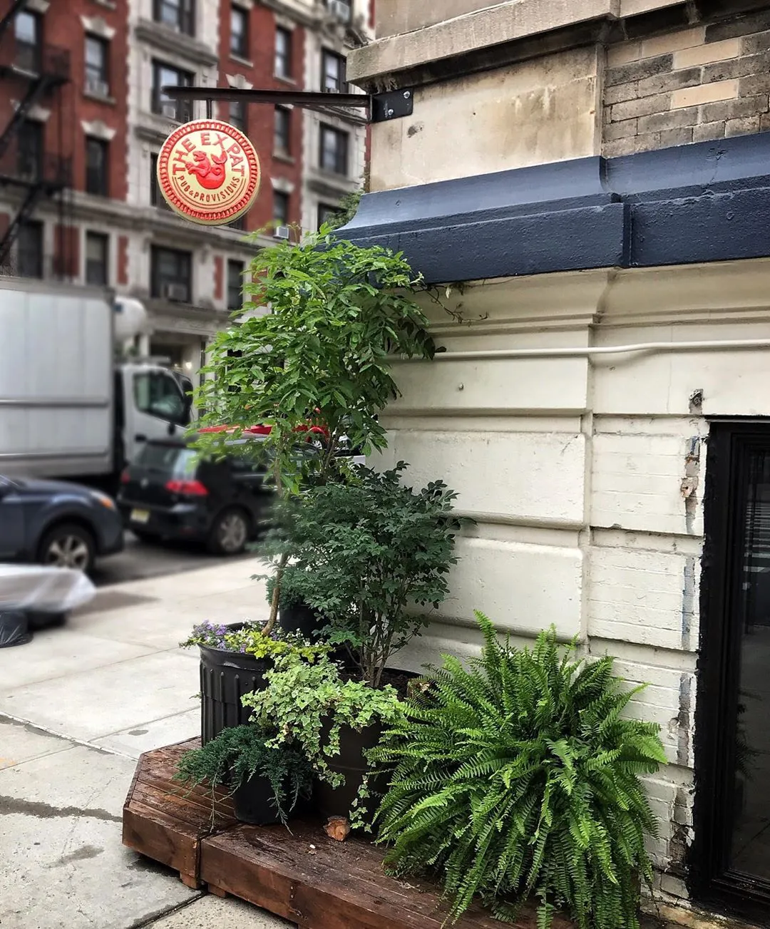Exterior photo of The Expat, showing the restaurant's red logo sign
