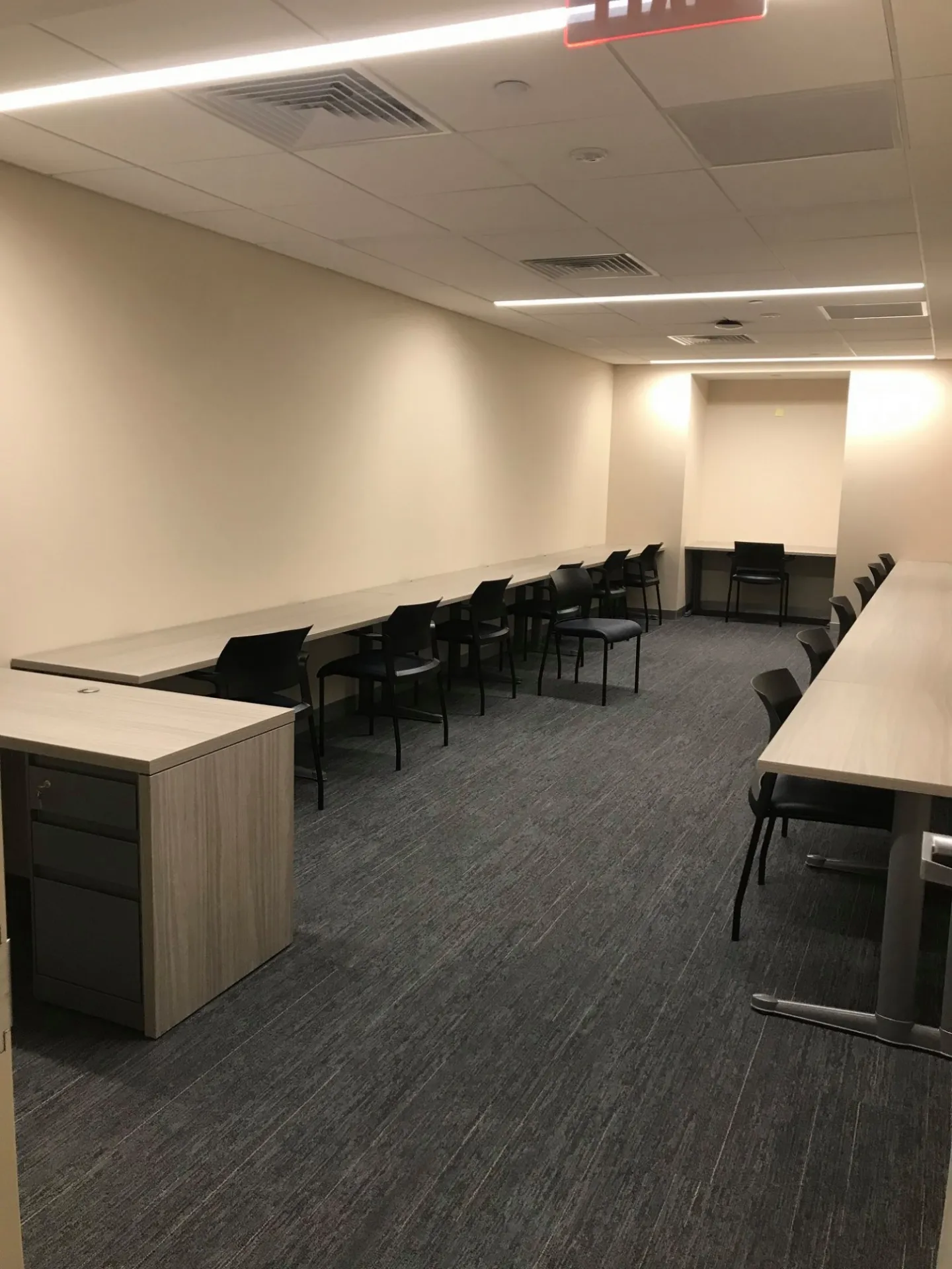Room with desks against a wall
