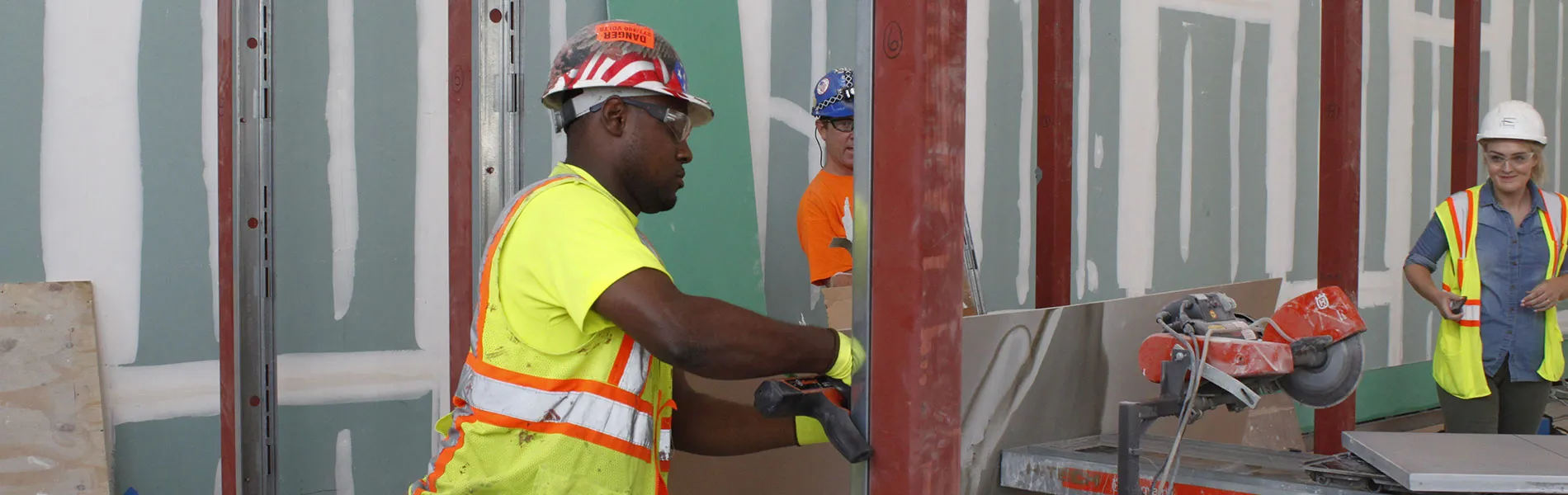 Construction workers putting up a wall