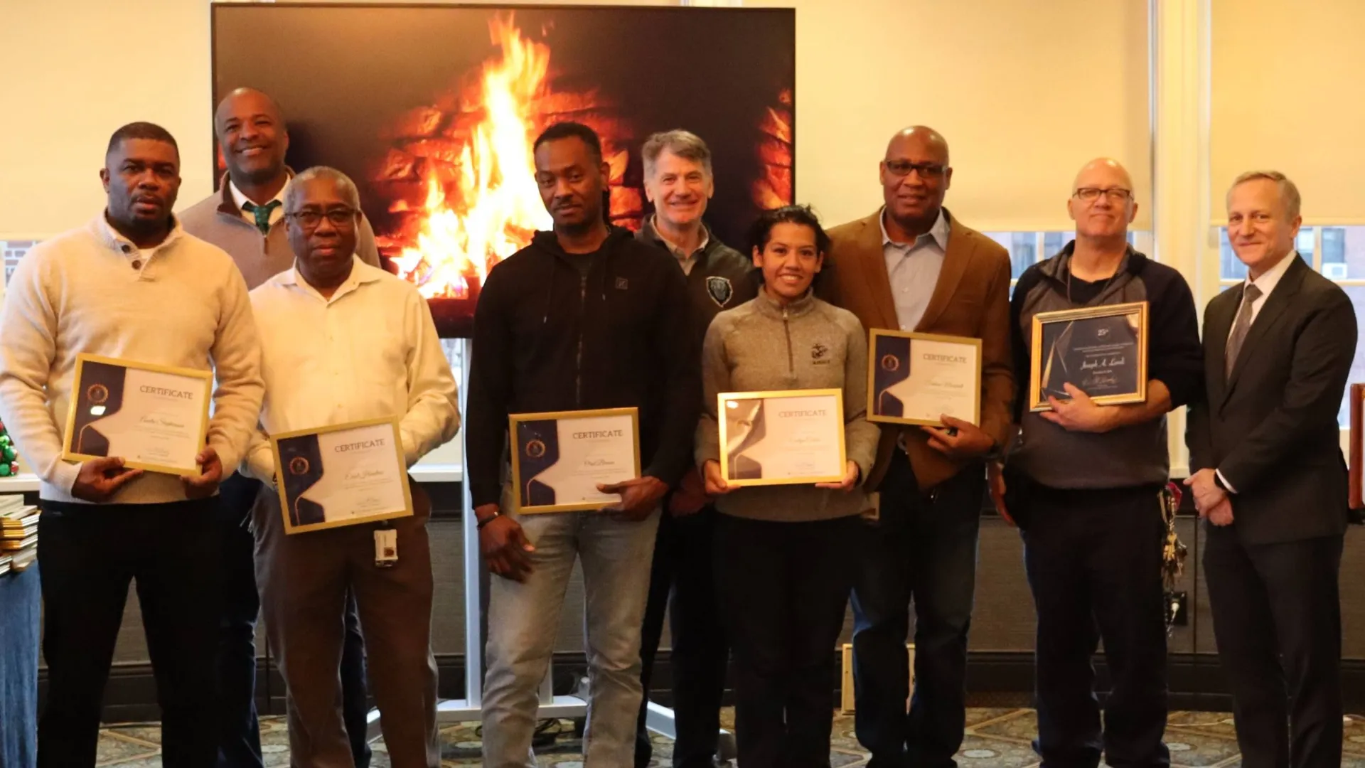 Group photo of the Operations team receiving certificates.