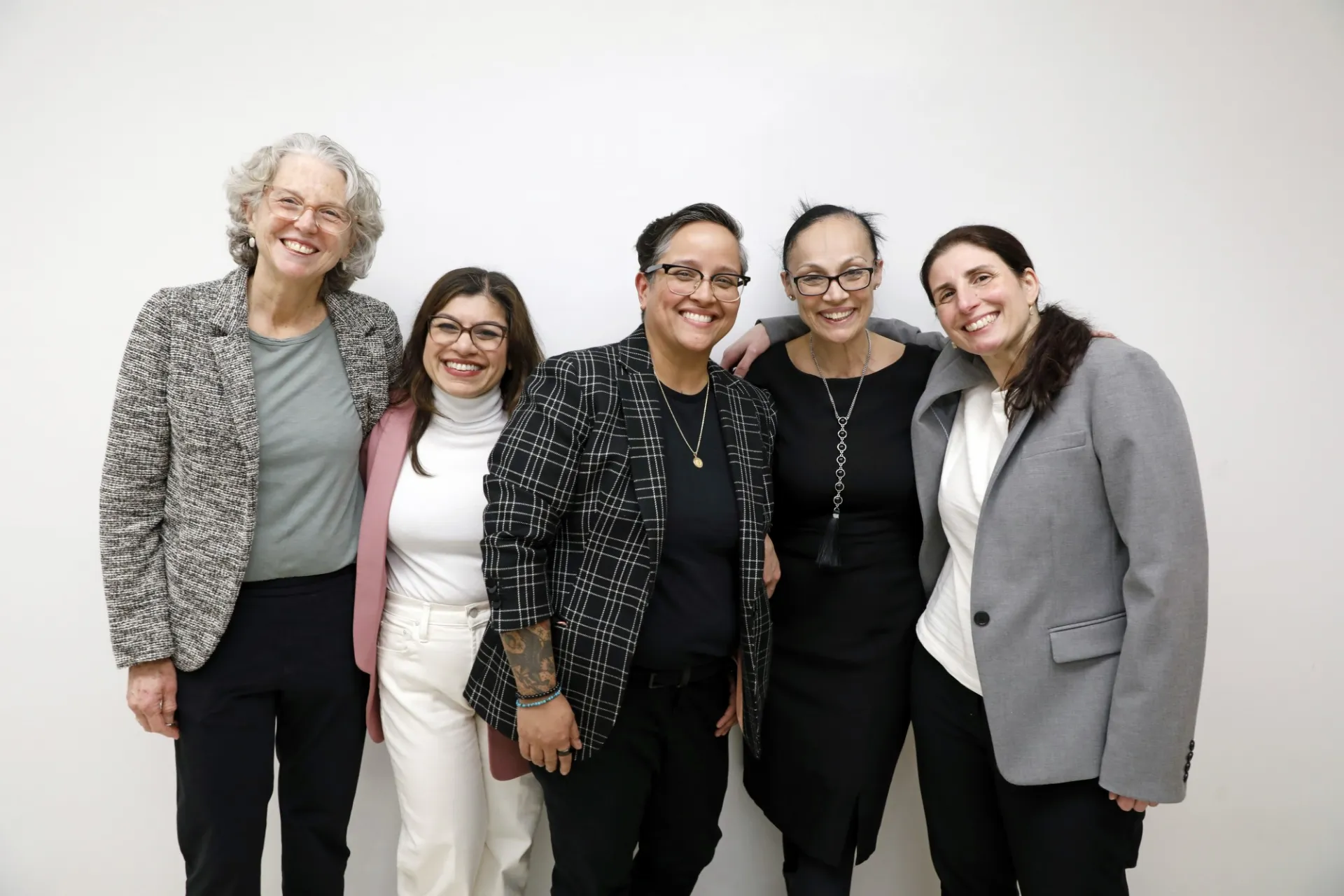 Shari Colburn, Sheetal Kale, Leilani Reynolds, Annette Lopes, and Antonella Contrera pose in front of a white wall.