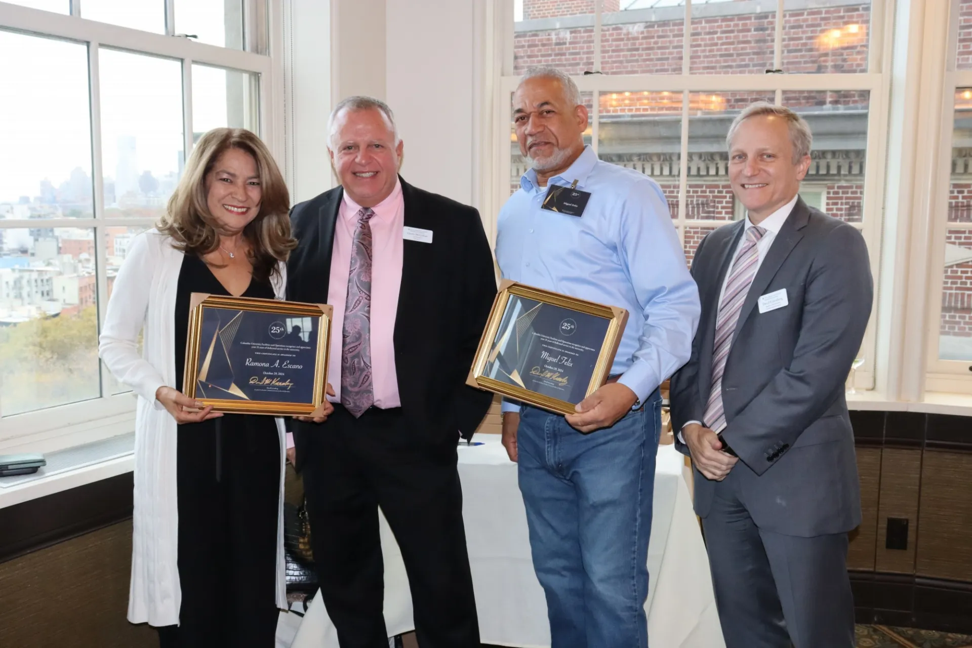 Operations employees pose with their supervisor and Executive Vice President David M. Greenberg