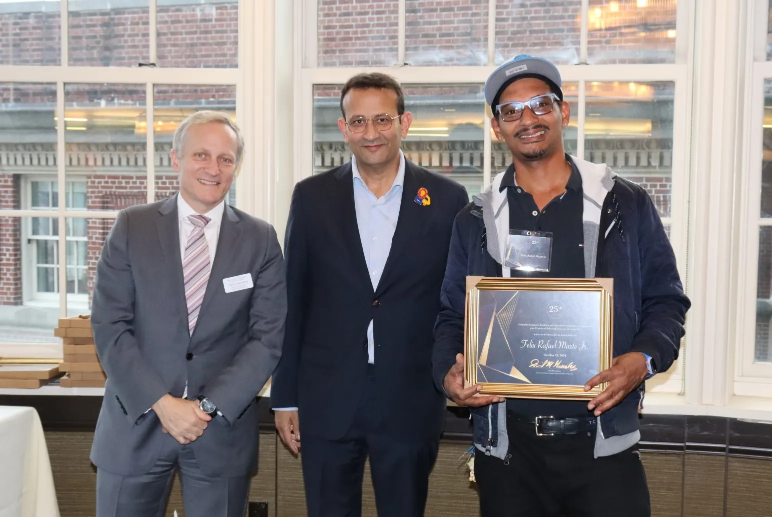 Campus Services employee poses with supervisor and Executive Vice President David M. Greenberg