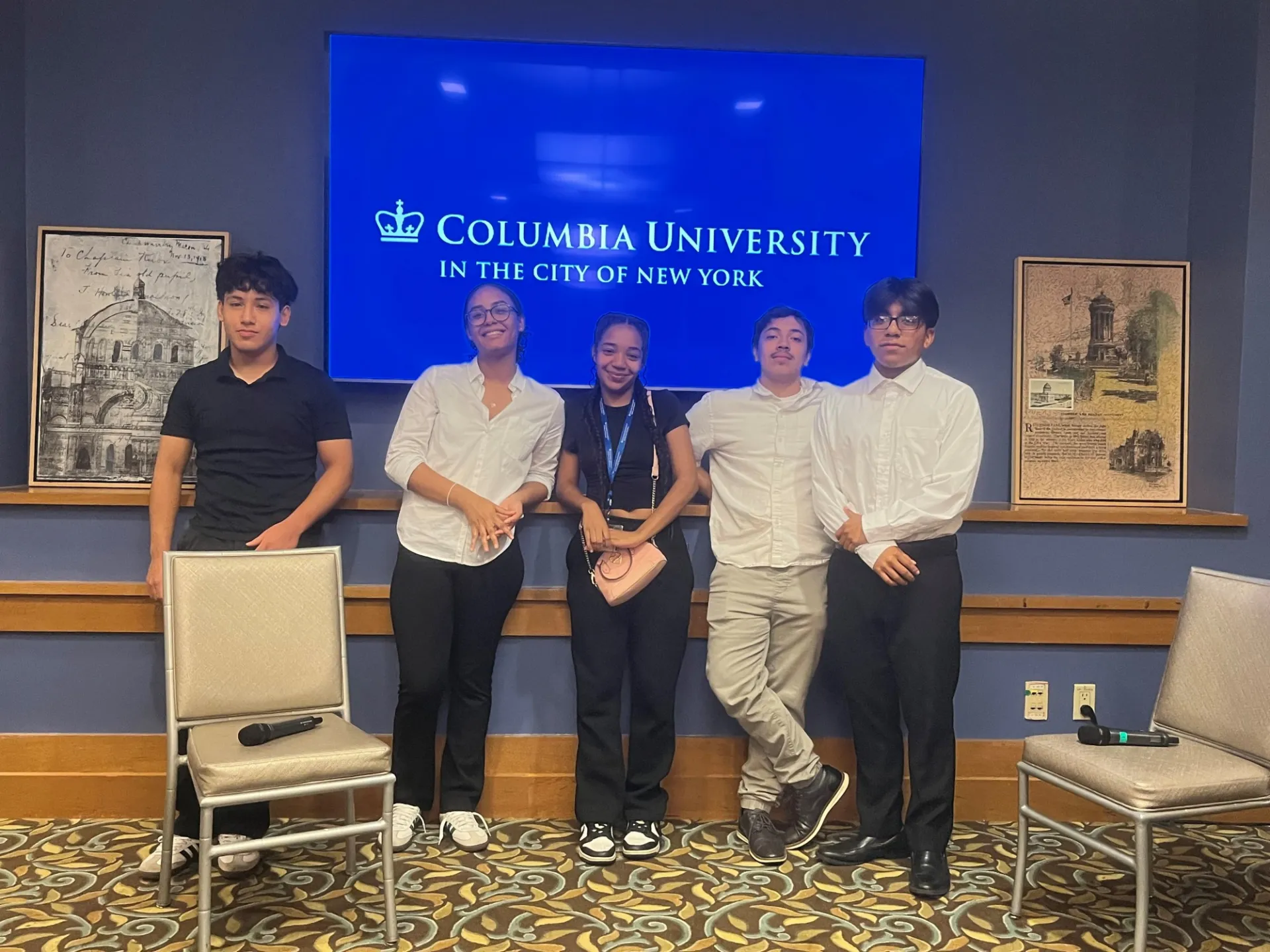 High school interns posing for a photo after giving their final presentation.