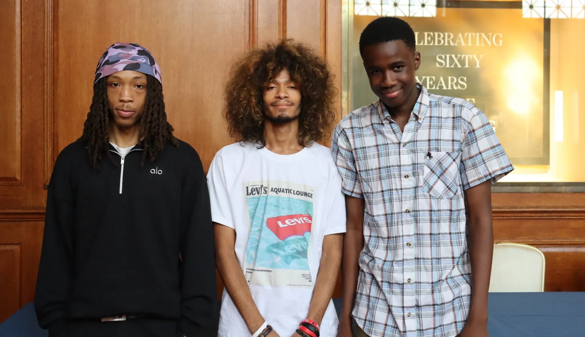 three high school students pose for photo in Low Library