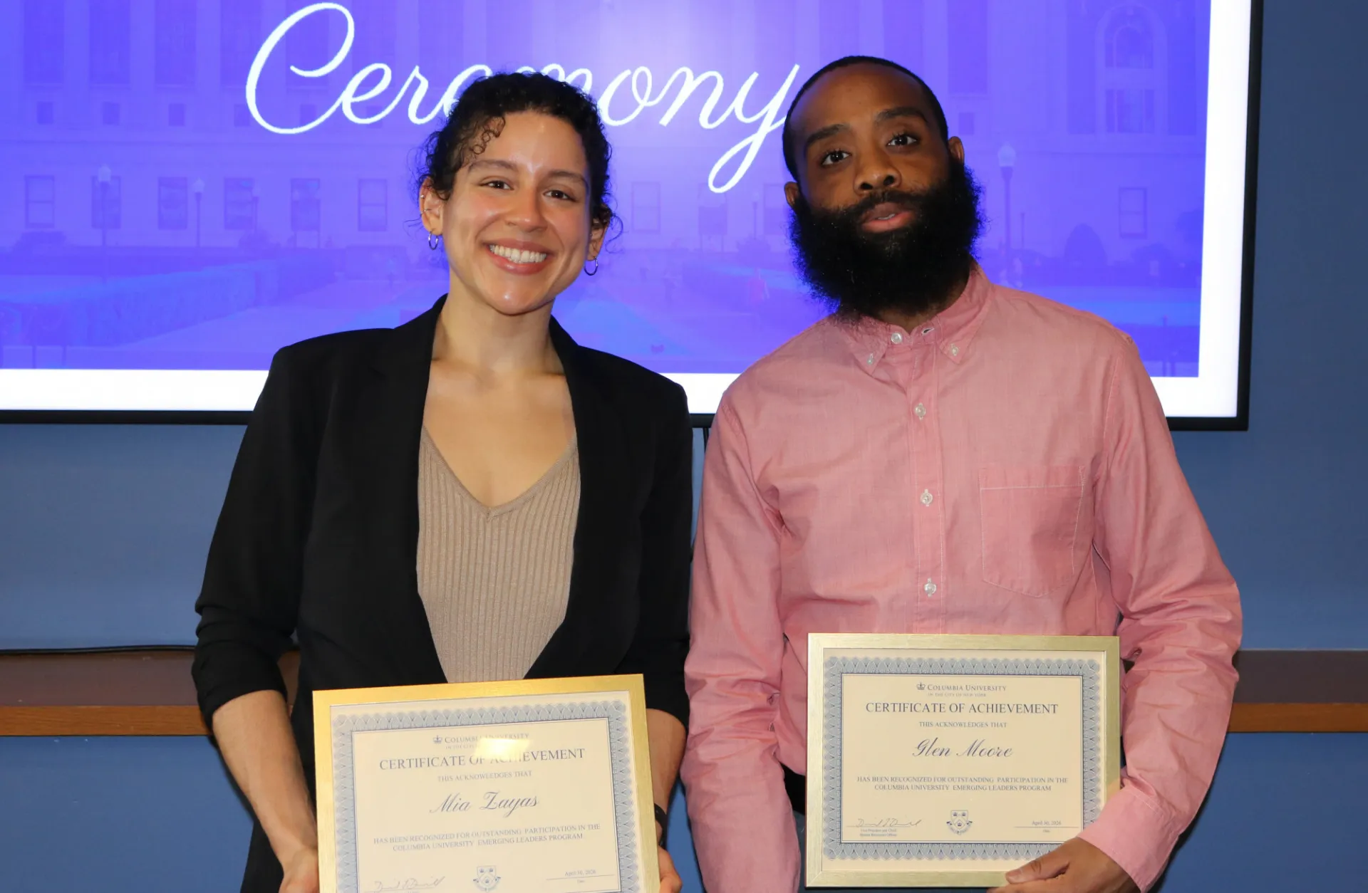 Mia DeLuis Zayas and Glen Moore hold certificates for their successful completion of the Emerging Leaders program