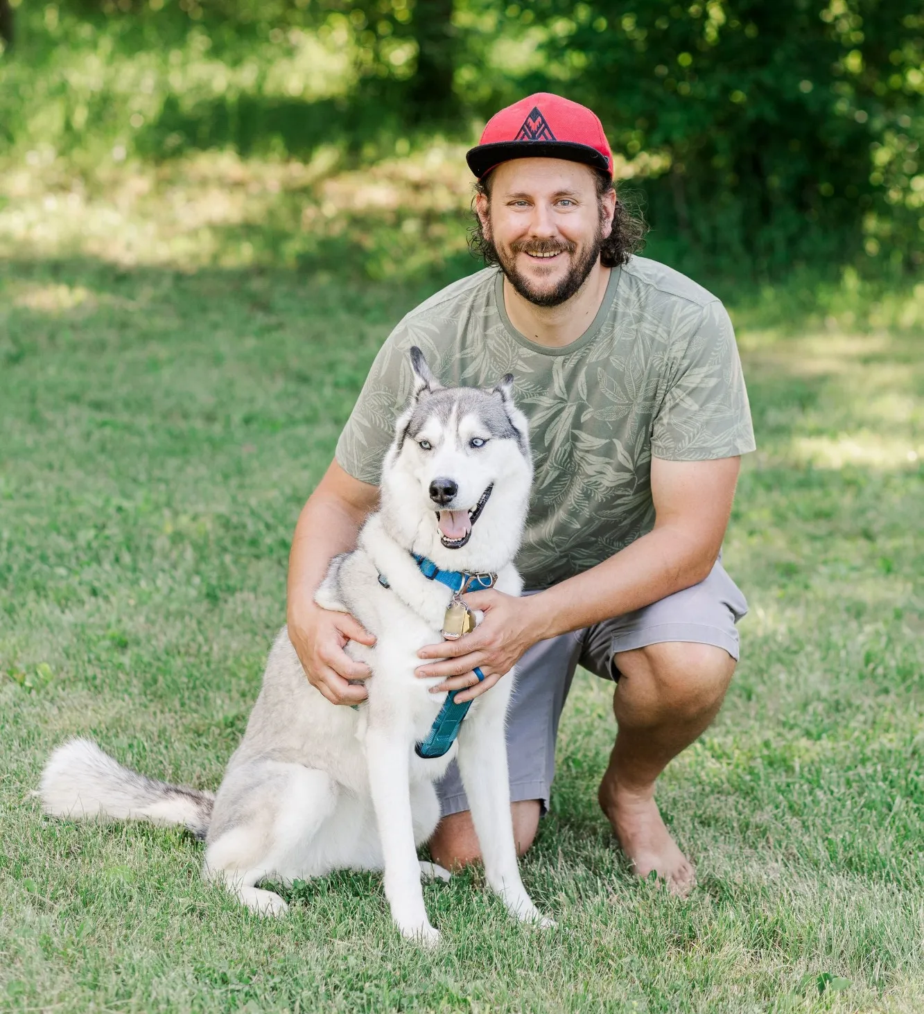 Dog posing with owner in a field