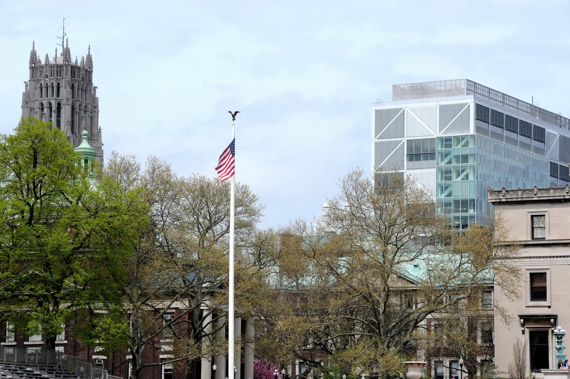 The west flagpole at the Morningside campus with a view of Northwest Corner in the background