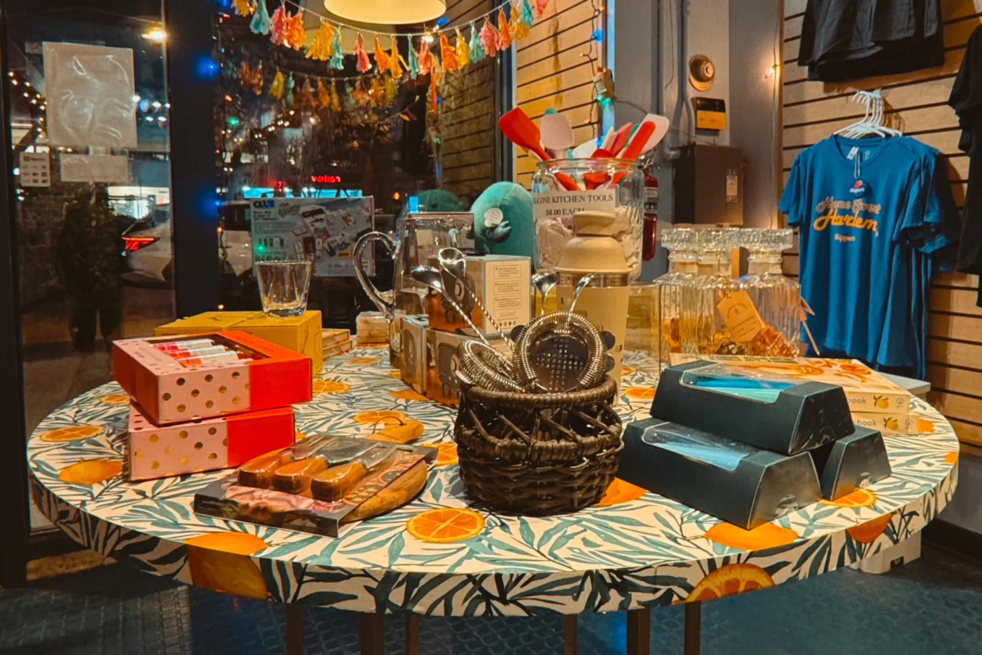 The interior of Skipper's which has a table full of different goods for sale, and a wall full of t-shirts.