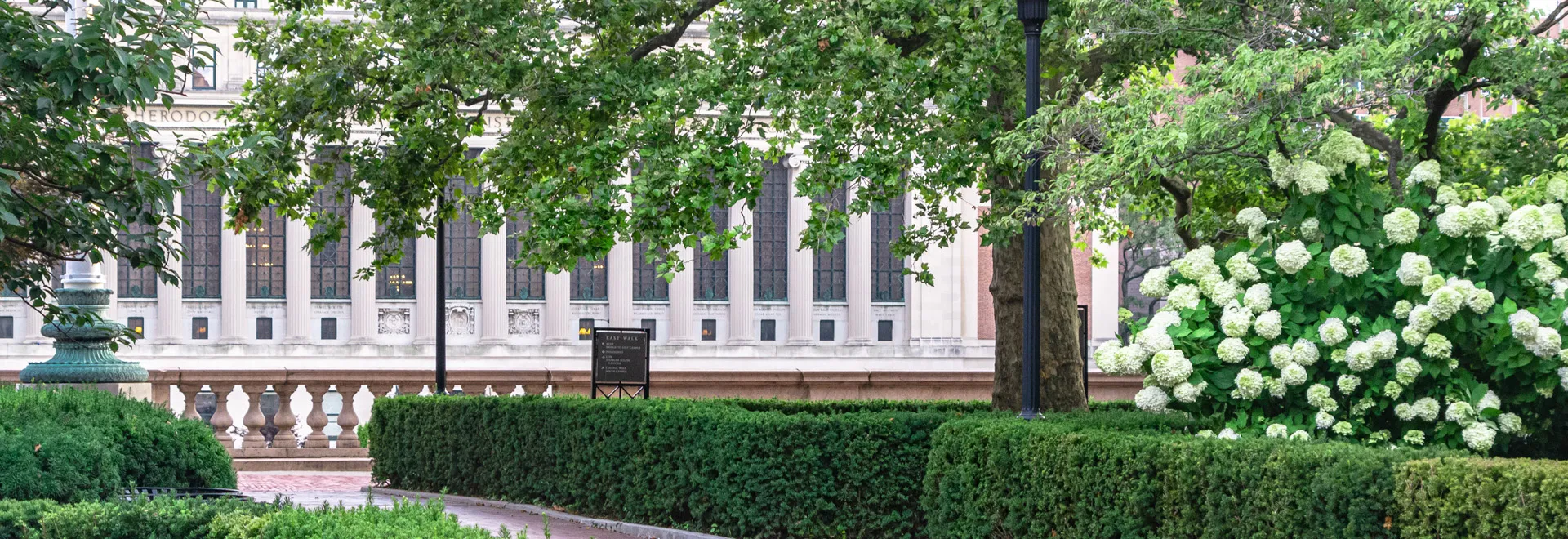 A view of Butler Library from Low Plaza during spring, with flowers in bloom.