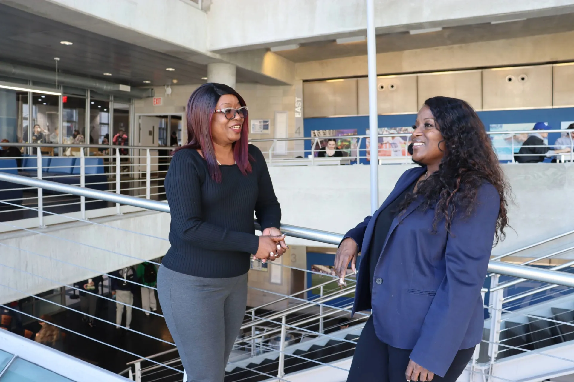 Tammie (left) and Nakia (right) talking and laughing on the ramps of Lerner Hall