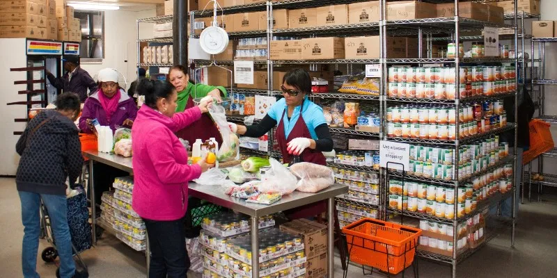 five people around a table sorting food