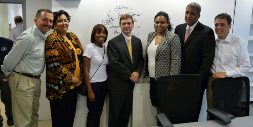  Jean and Juana Gauthier (third and second from farthest right) of Innovative Business Solutions with Columbia University Executive Vice President Joe Ienuso (center) and members of the Columbia University project team after signing their names to a wall,  signifying that they stand behind their work.  