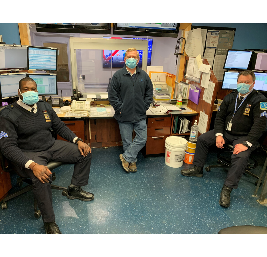 public safety men with masks in room with computers