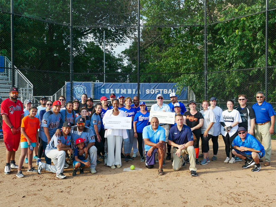 Several members of the Columbia staff softball league pose with Christa Hill of Columbia Community Service and Ross Frommer of the Medical Center Neighborhood Fund, both holding the checks presented for charity. Teams shown include Big League Chews: Undergrad Student Life; Da’ Bunts: Office of Alumni and Development; Elite Squad: Materials Management at NYP; Legends: Columbia Psychiatry; MVP Builders: Manhattanville Development Group; Silverbacks: CUIT; Warriors: Endoscopy Suite (NYP); Highlanders: CUIMC Faculty Club; Diablitos: Campus Services; Athletics; Takeover: Dept of Obstetrics/Gyn; and the Pinguinos: Columbia Dining. Photo: Caroline Moore/Campus Services Several members of the Columbia staff softball league pose with Christa Hill of Columbia Community Service and Ross Frommer of the Medical Center Neighborhood Fund, both holding the checks presented for charity. Photo: Caroline Moore/Campus Services