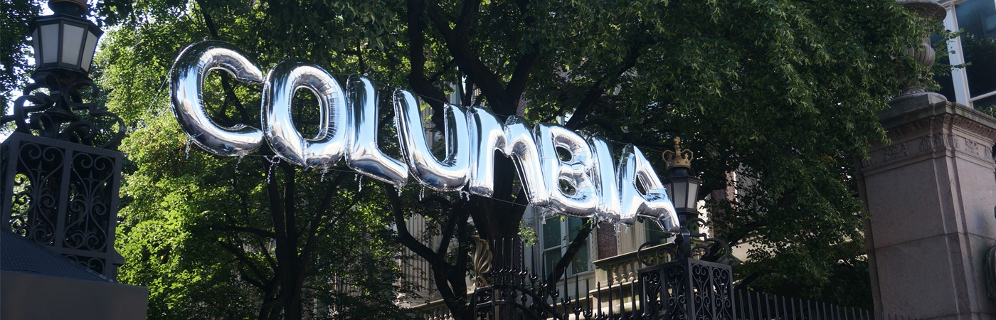 Columbia written in large, silver mylar balloons, which hangs above the College Walk entrance.