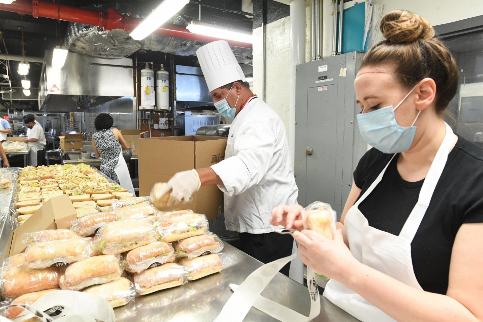 Chef Mike and JJ's Place manager Christina prepare and wrap sandwiches in John Day Dining Hall