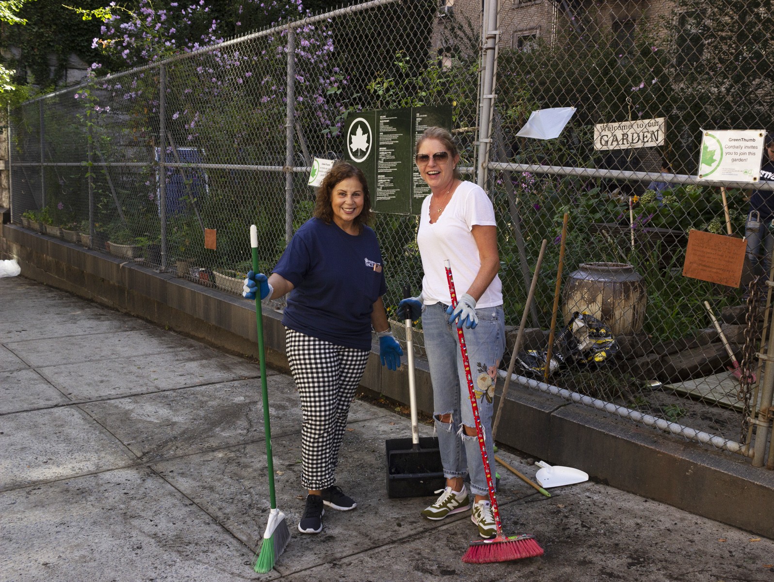 Volunteers stand in front of garden entrance. Volunteers stand in front of garden entrance
