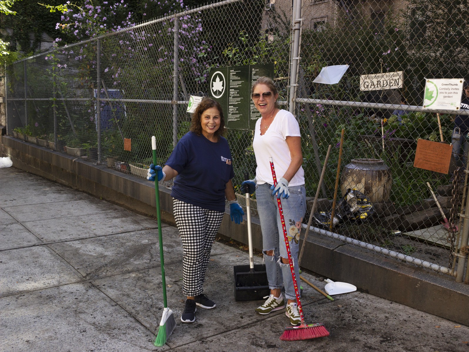 Volunteers stand in front of garden entrance