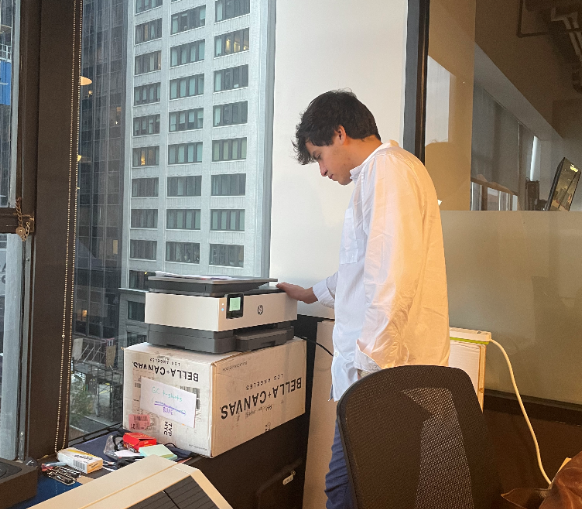 An employee from Generation Citizen, Inc. using the new printer donated by Columbia University.