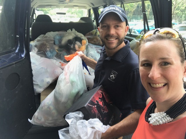 Jessica Prata and Dan Allalemdjian of the Environmental Stewardship team dropping off donations at Catholic Charities