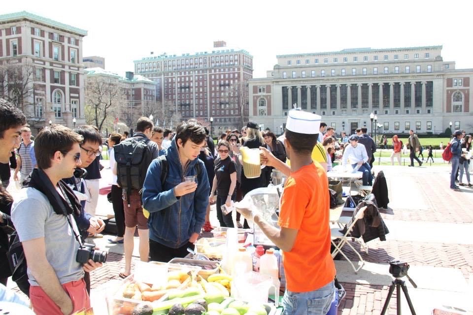 Owner Abdusalam Abajebel gives out samples of juice to students on College Walk.