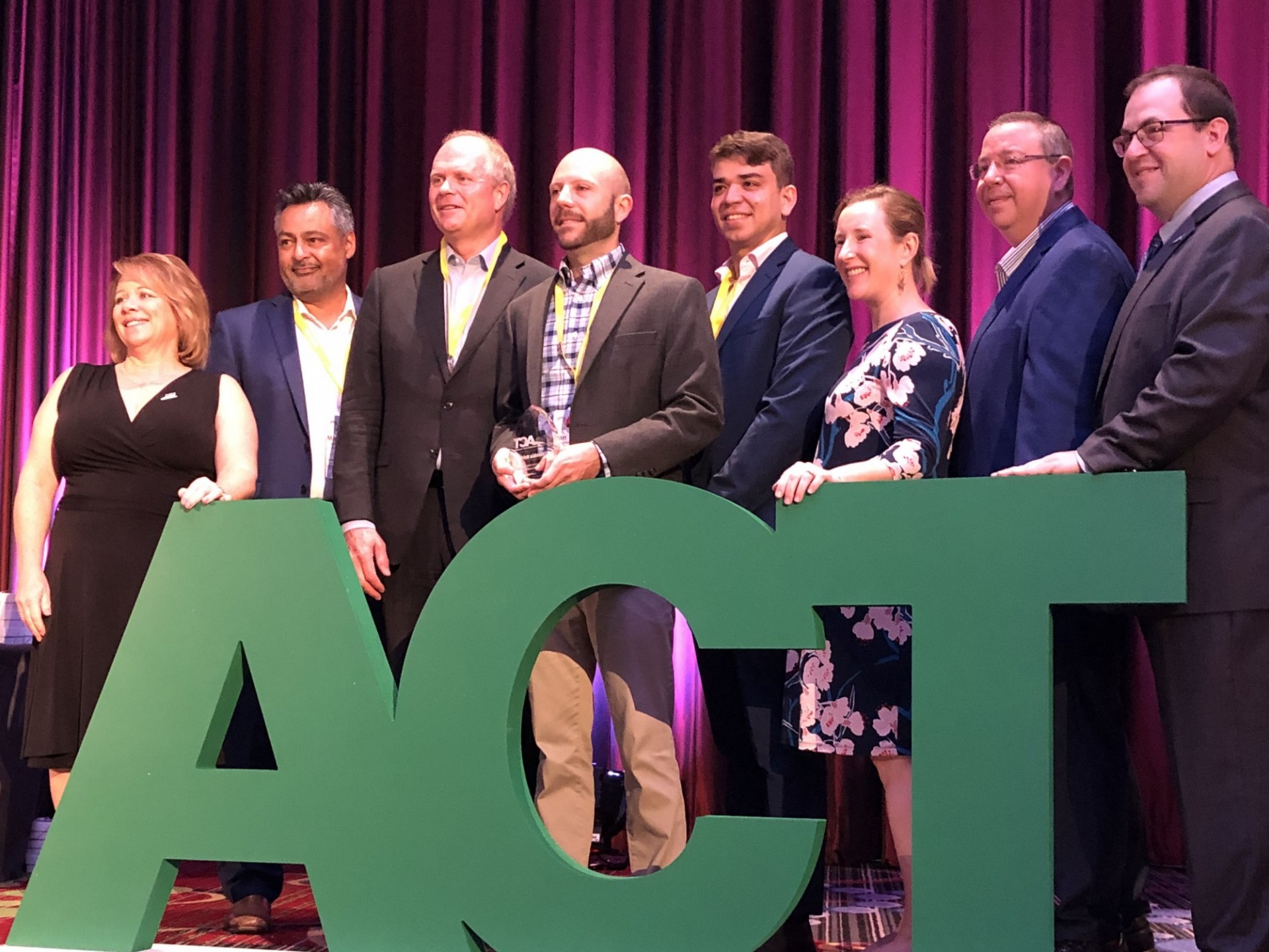 Columbia University representatives from the Transportation and Environmental Stewardship offices accept the award from ACT at the International Conference on August 7, 2019.
